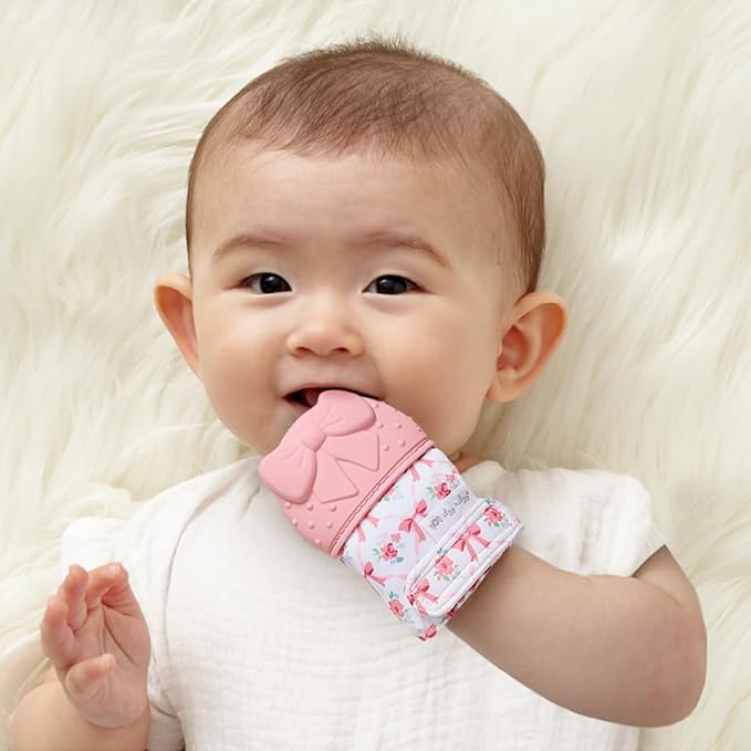 Itzy Ritzy Silicone Teething Mitt - Soothing Infant Teething Mitten with Adjustable Strap, Crinkle Sound & Textured Silicone to Soothe Sore & Swollen Gums - for Ages 3 Months & Up (Bow)