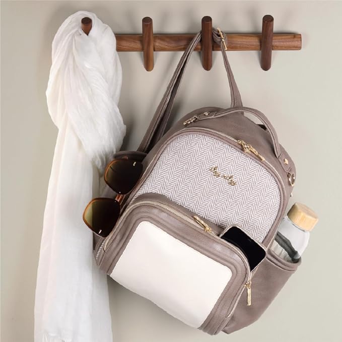 Itzy Ritzy Mini Diaper Bag Backpack – Chic, Compact Mini Plus Backpack with Changing Pad, 10 Pockets (6 Internal, 4 External), Grab-Top Handle & Rubber Feet (Vanilla Latte)