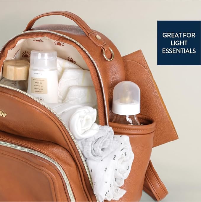 Itzy Ritzy Mini Diaper Bag Backpack – Chic, Compact Mini Plus Backpack with Changing Pad, 10 Pockets (6 Internal, 4 External), Grab-Top Handle & Rubber Feet (Cognac)