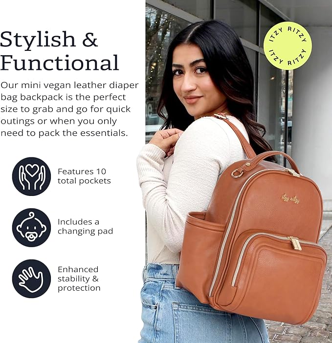 Itzy Ritzy Mini Diaper Bag Backpack – Chic, Compact Mini Plus Backpack with Changing Pad, 10 Pockets (6 Internal, 4 External), Grab-Top Handle & Rubber Feet (Cognac)